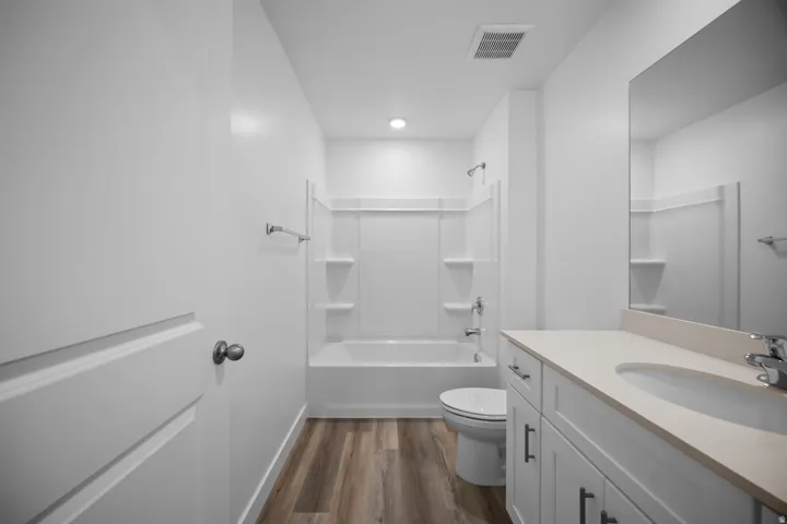 White wood-finish vanity with a light-toned countertop