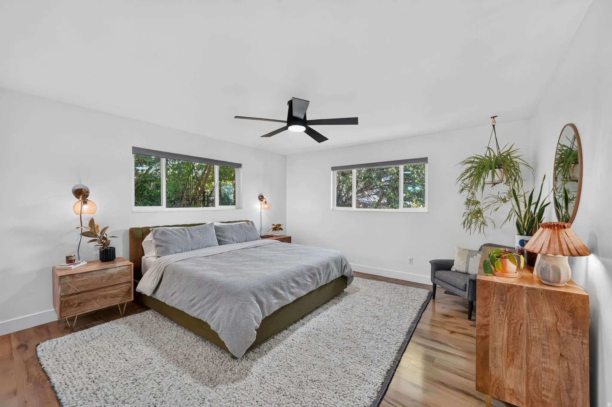 Recessed lighting, wood-finish flooring, two windows, and a ceiling fan with light fixture