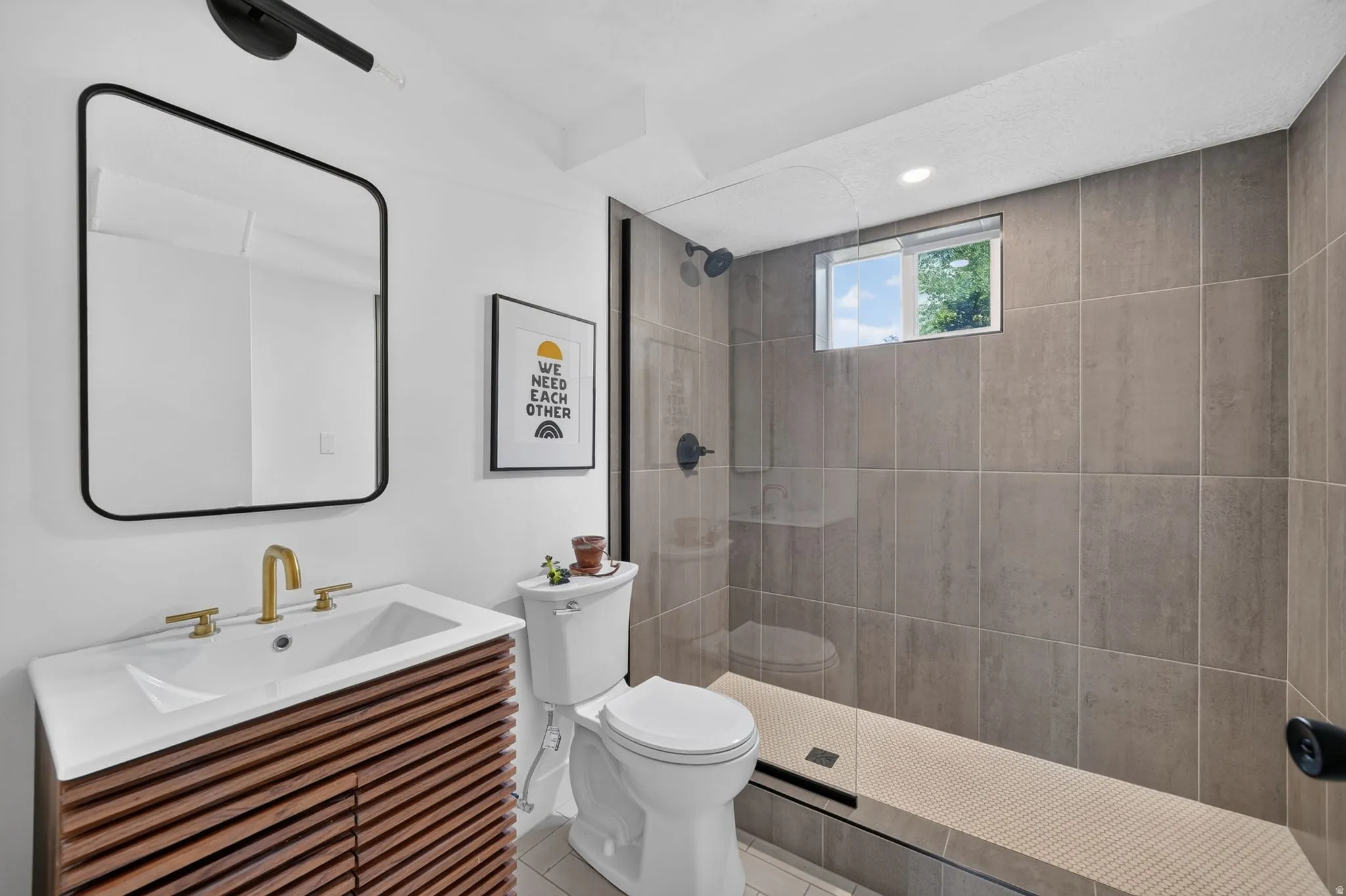 Walk-in shower with full-height tile surround and glass enclosure