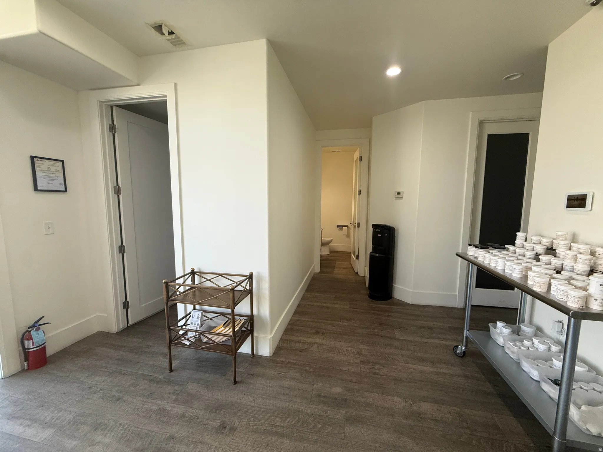 Wood-finish flooring, recessed lighting, and crisp white walls throughout