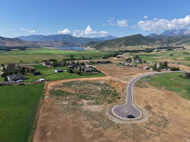 Expansive land parcel featuring a paved cul-de-sac and mountain backdrop