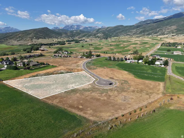 Expansive lot with a clear building envelope, surrounded by open fields and distant mountains