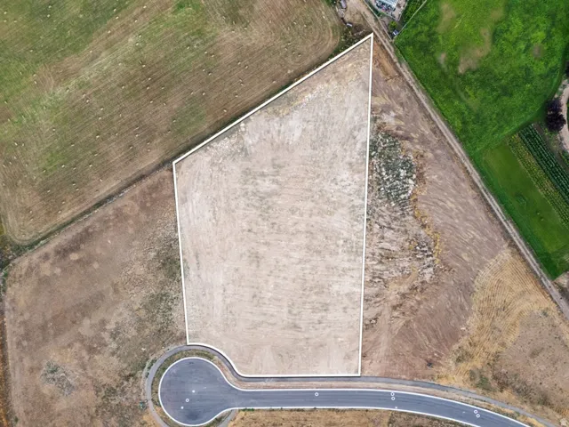 Developable lot with a clear perimeter, cul-de-sac access, and surrounding cultivated land