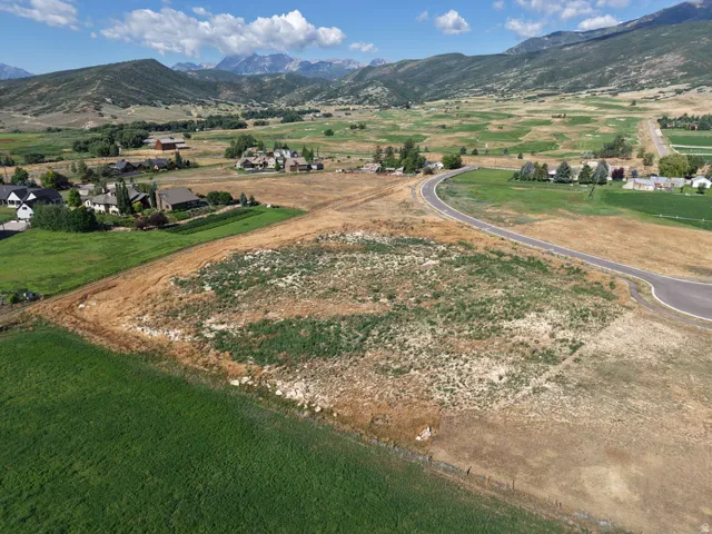 Expansive rural lot featuring a paved road and mountainous backdrop