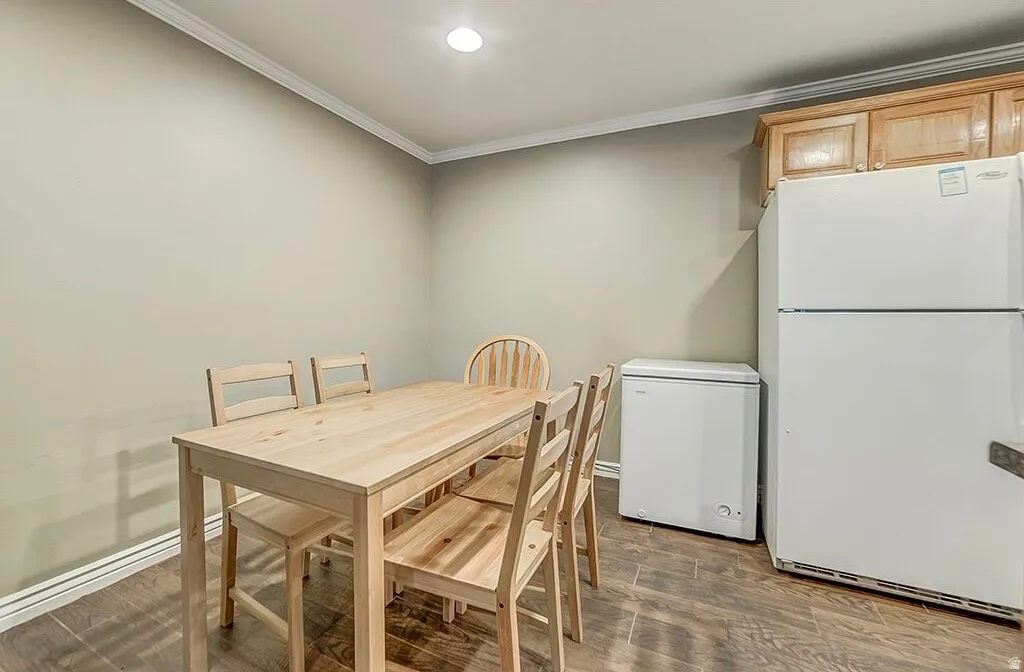 Wood-finish flooring with crown molding and recessed lighting