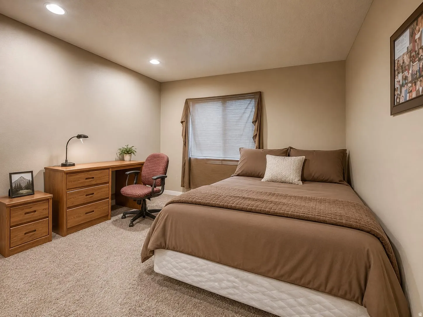 Recessed lighting, wood-finish desk with drawers, window with blinds, neutral-toned walls, and carpeted flooring