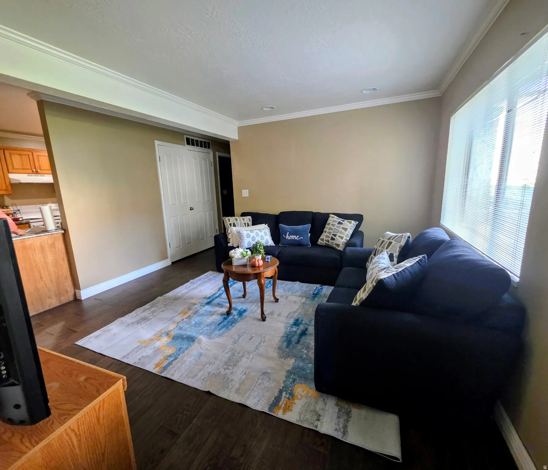Recessed lighting, crown molding, wood-finish flooring, and a window with blinds