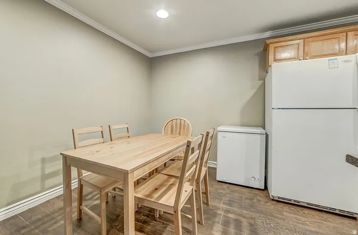 Wood-finish flooring with crown molding and recessed lighting