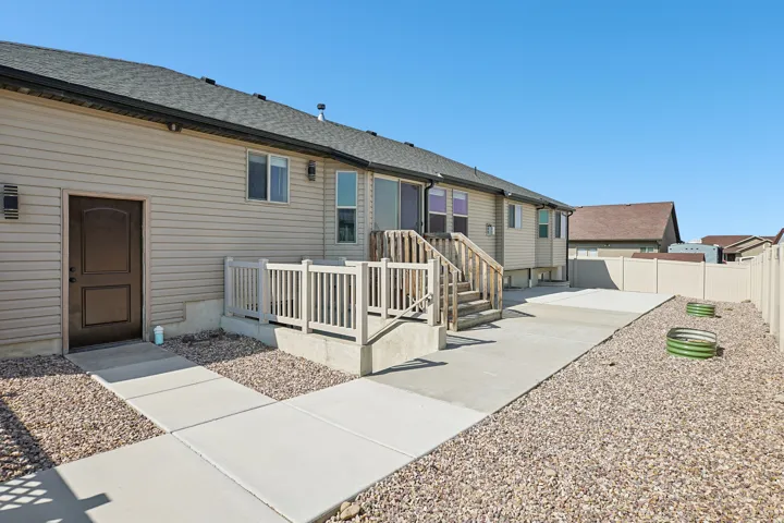 Exterior featuring siding and a composite shingle roof