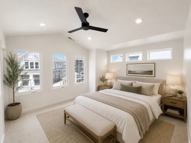 Vaulted ceiling with recessed lighting and a ceiling fan