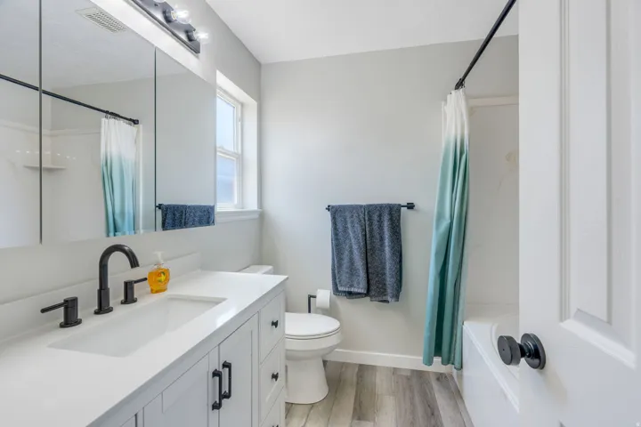 Master bathroom featuring a newer vanity with rectangular vessel sink, quartz countertop, and matte black faucet
