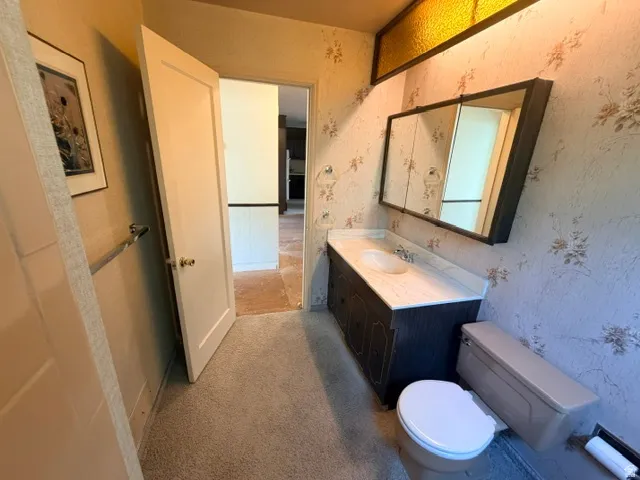 Full bathroom with a single vanity, a mirrored medicine cabinet, and a toilet.