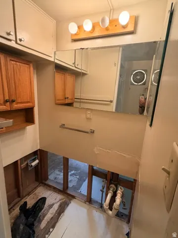 Upper portion of 3/4 bath over sink and toilet connections.