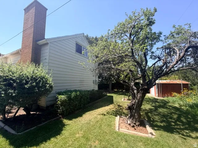 Addition to the home with a prominent brick chimney and secluded and tastefully appointed fenced back yard.