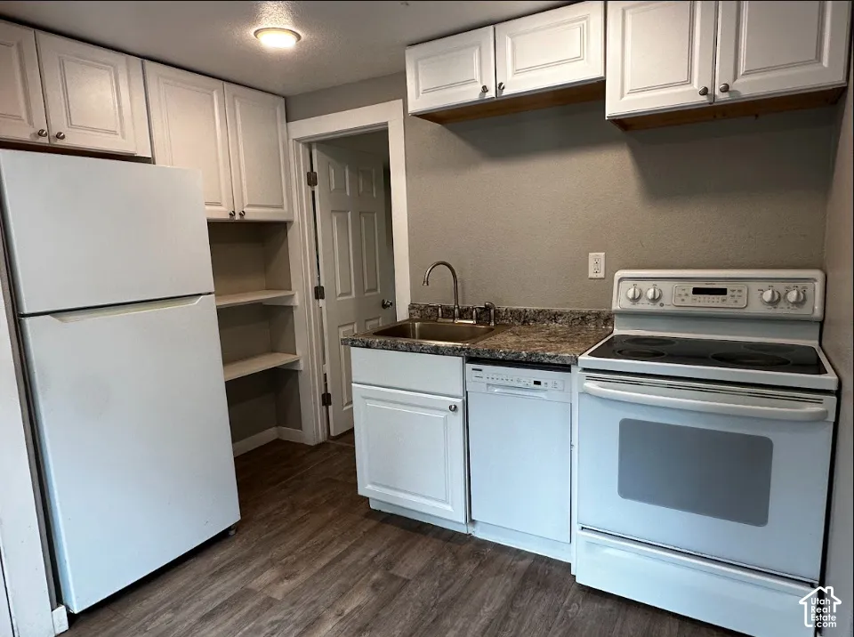 Kitchen featuring wood-finish flooring, white cabinetry, a refrigerator, an electric range, and a dishwasher
