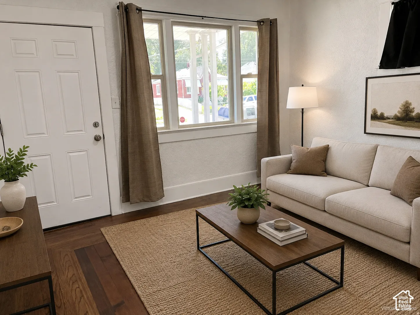 (Front Unit) Wood-finish flooring throughout, white paneled door, and bright window with natural light