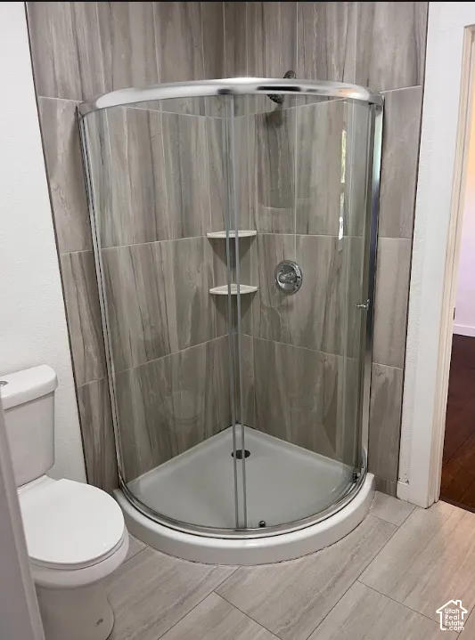 (Front Unit) Corner shower enclosure with clear glass panels, chrome hardware, and integrated shelving