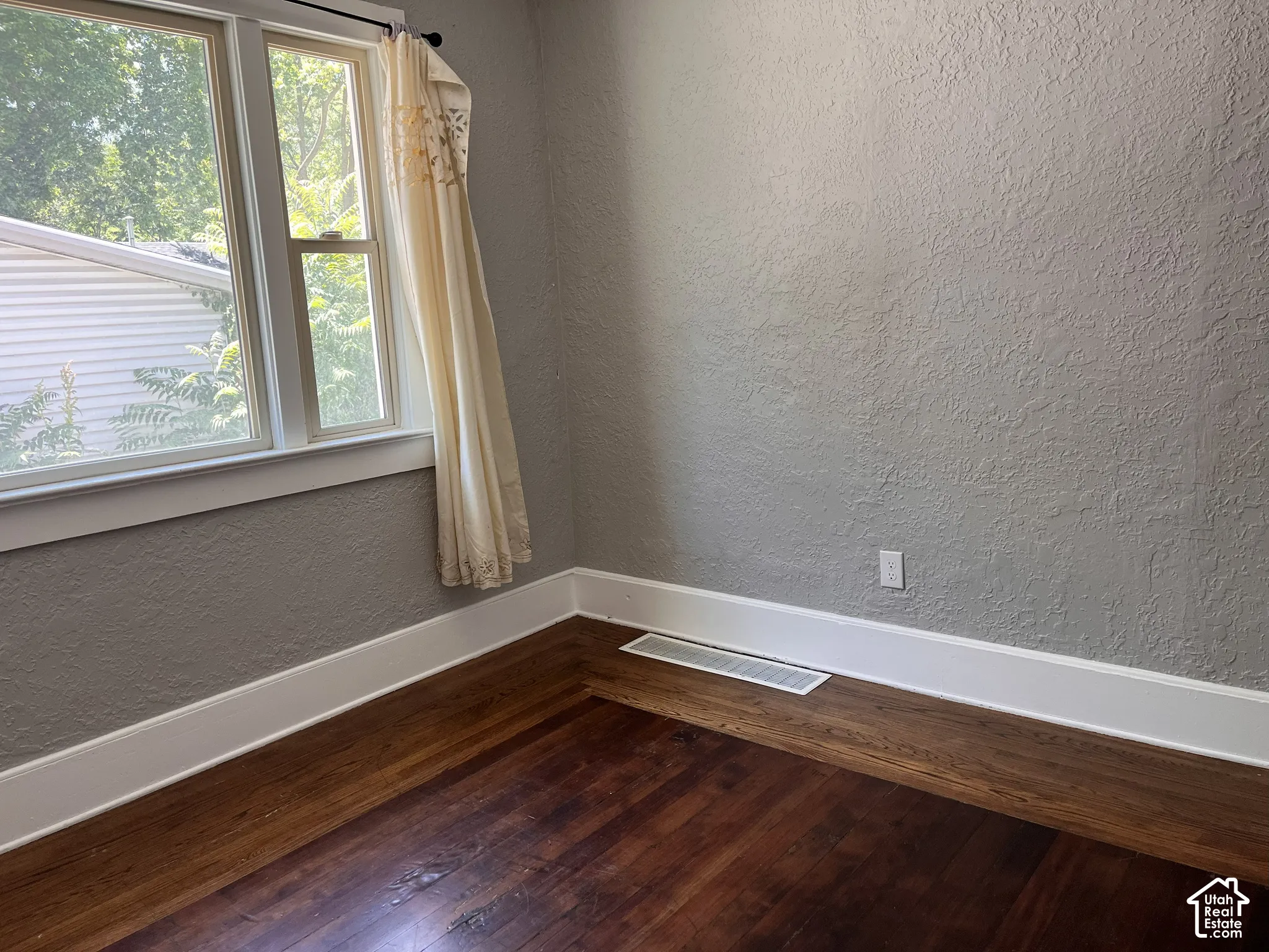 (Front Unit) Hardwood flooring, painted textured walls, white trim, and double-hung windows