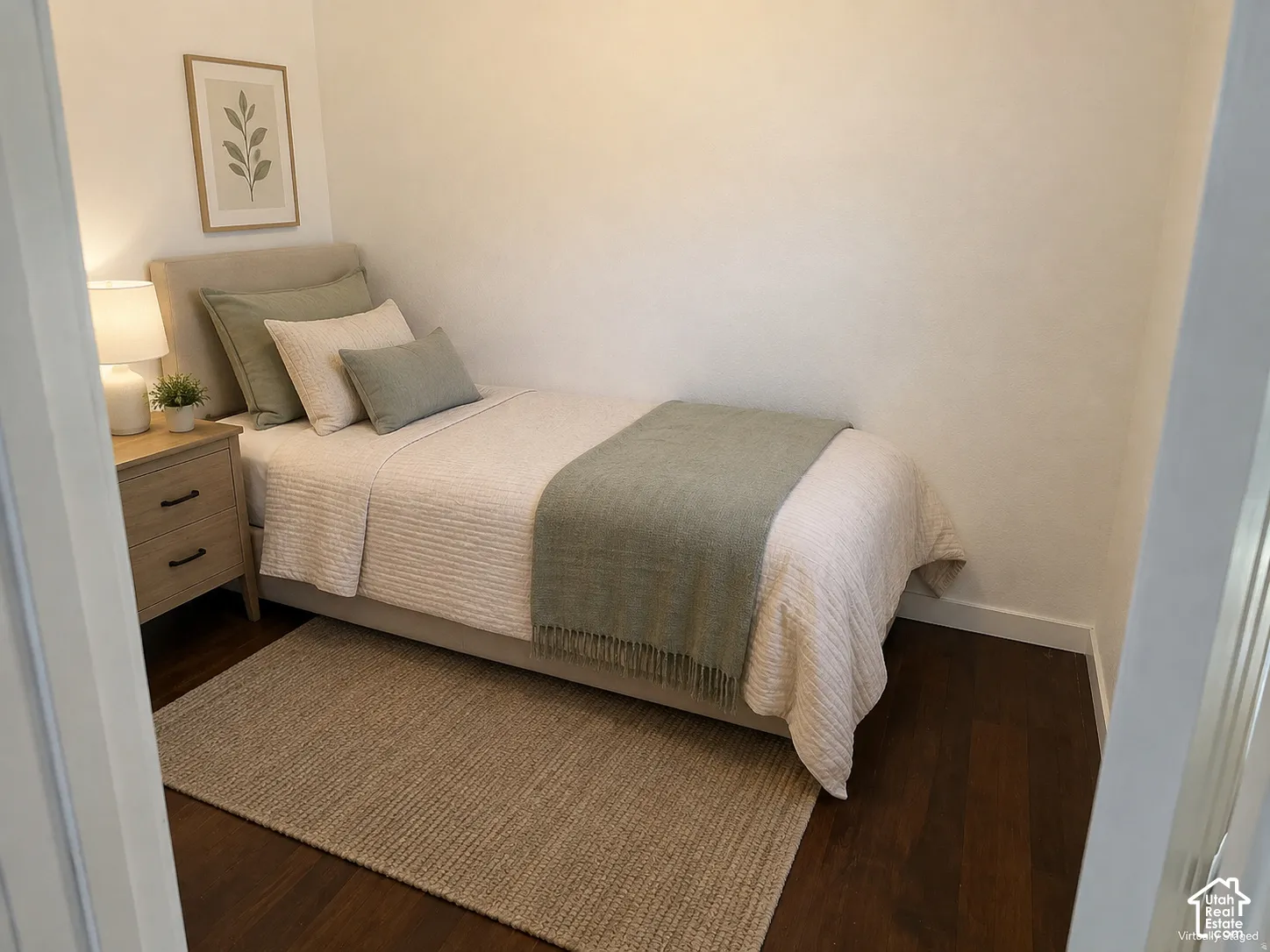 (Front Unit) Wood-finish flooring with white baseboards, featuring a light-toned nightstand with dark hardware