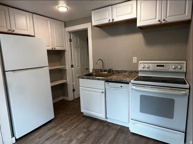 Kitchen featuring wood-finish flooring, white cabinetry, a refrigerator, an electric range, and a dishwasher