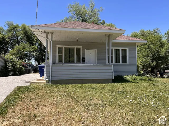 Light gray siding exterior with a covered front porch featuring white columns