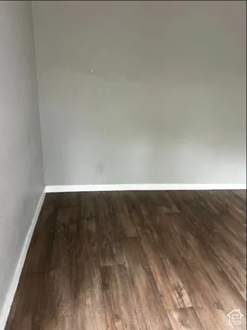 Wood-finish flooring with white trim and light gray walls