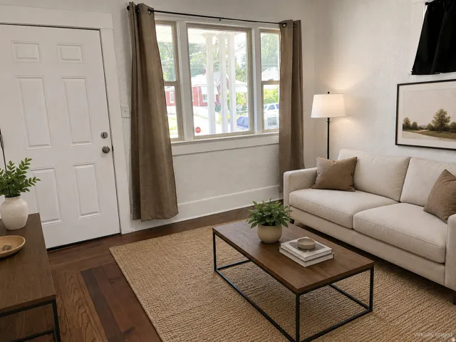 Wood-finish flooring throughout, white paneled door, and bright window with natural light