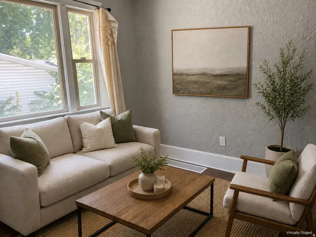 Multiple large windows, textured wall finish, and dark wood-finish flooring