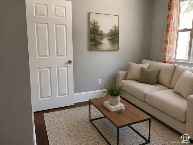 (Front Unit) Hardwood flooring with baseboard trim, and a window with natural light