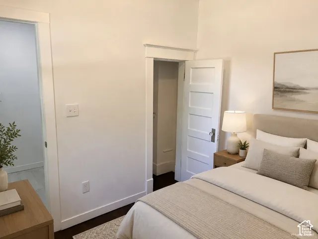 (Front Unit) Dark wood-finish flooring with white trim, a four-panel interior door, and light-colored walls