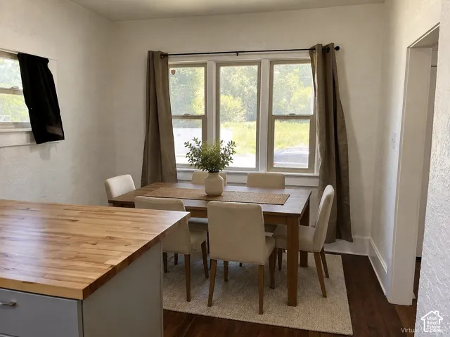 (Front Unit) Wood-finish flooring, white trim, and a window frame with multiple panes