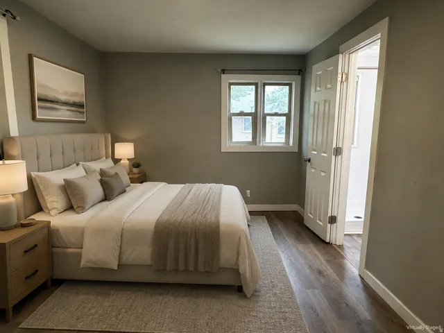 Wood-finish flooring, white window trim, and a paneled interior door