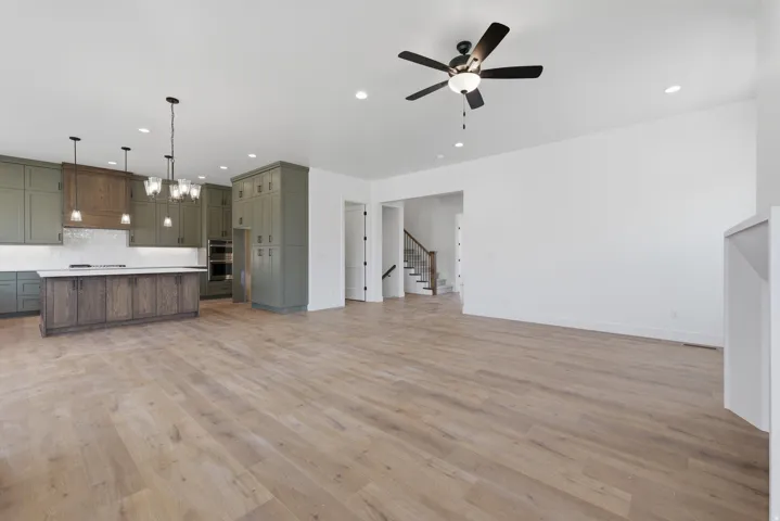 Open-concept living space featuring wood-finish flooring, recessed lighting, and a modern ceiling fan