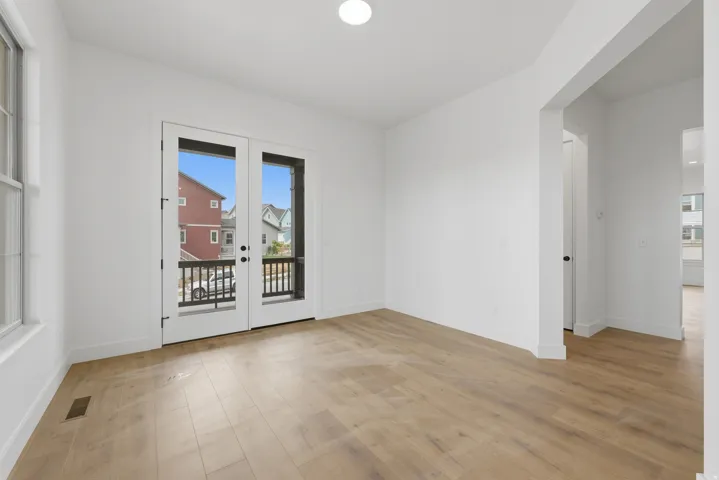 Wood-finish flooring, white walls, and a recessed ceiling light