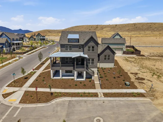 Contemporary gray exterior with multiple gables and a metal roof accent