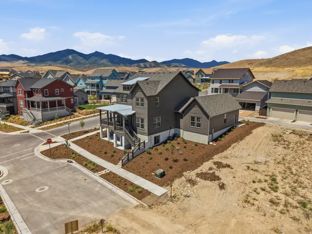 Two-story residence featuring a covered front porch and an attached garage