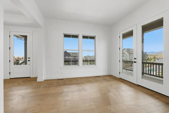 Wood-finish flooring with white walls and trim