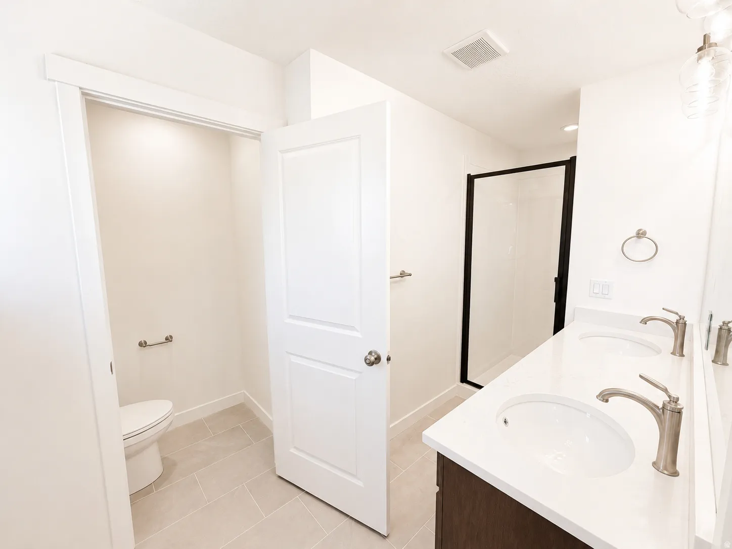 Dual vanity with undermount sinks and brushed nickel faucets