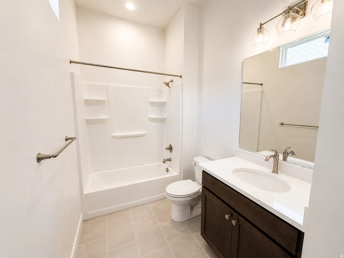 White single-piece tub and shower with integrated shelving