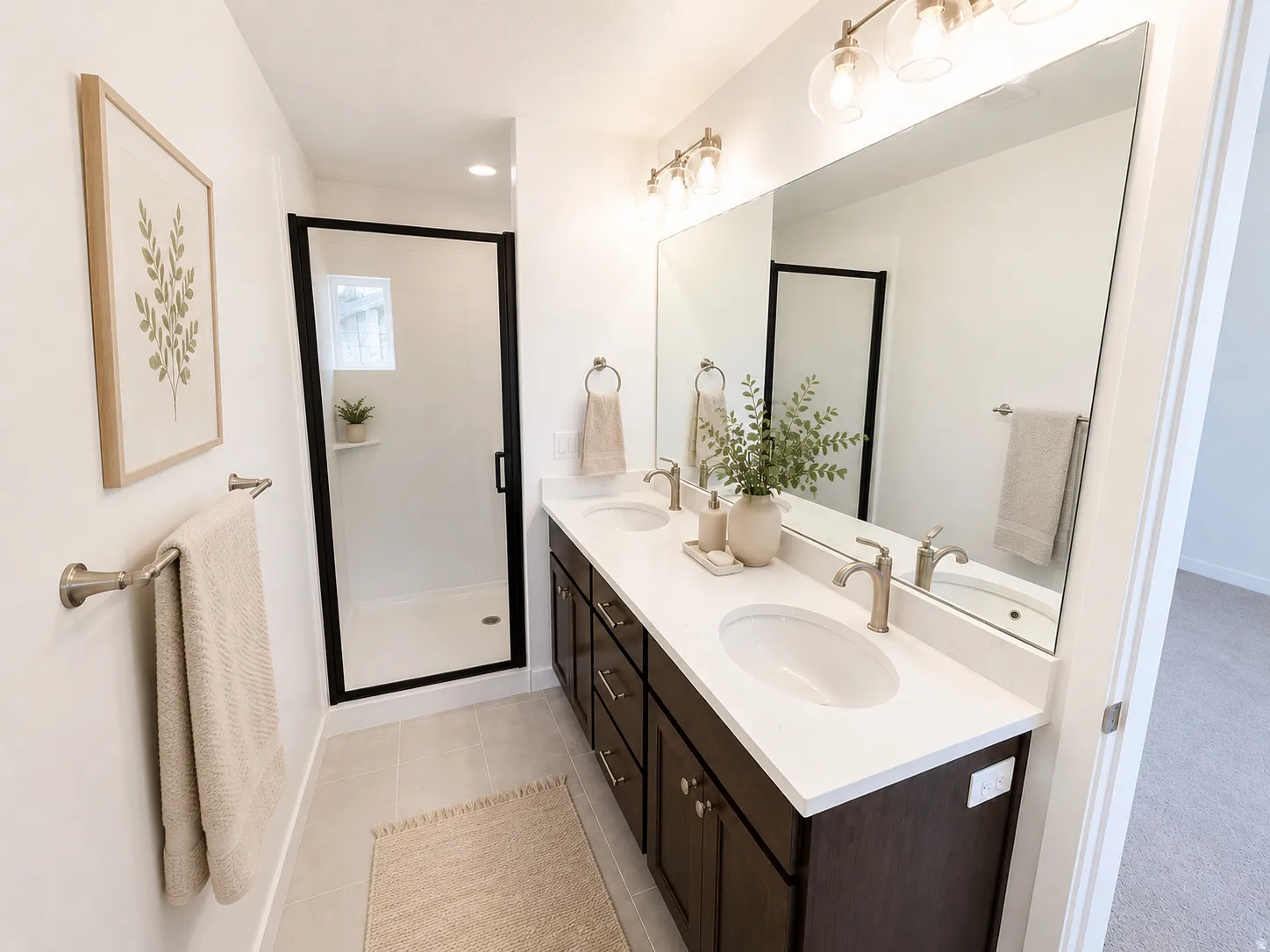 Dual vanity with undermount sinks, stone-look countertop, and dark wood-finish cabinetry
