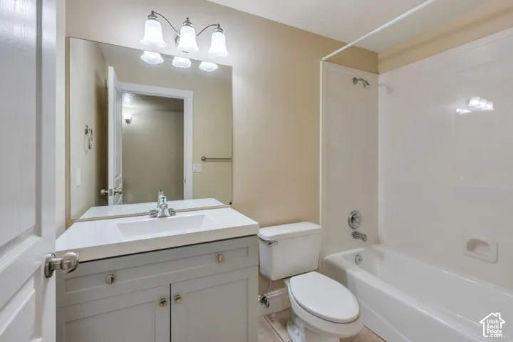 Bathroom featuring a vanity with a light gray cabinet, a white countertop, and an integrated sink