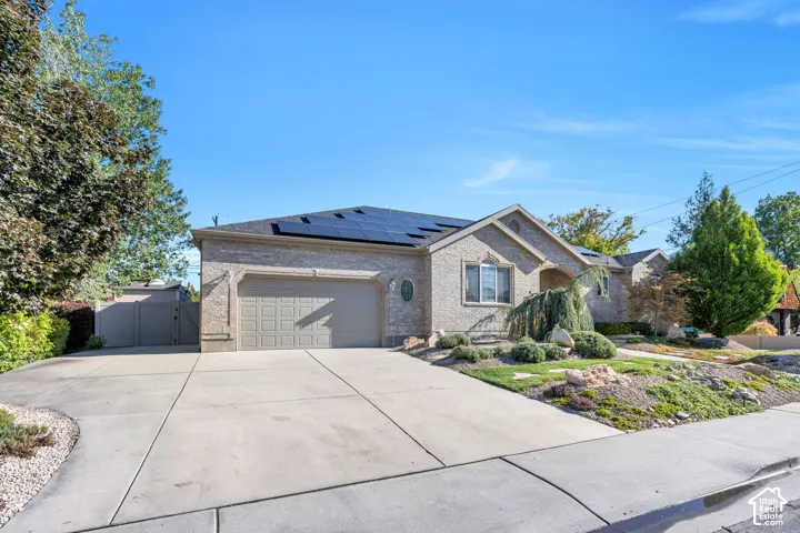 Brick exterior with a gabled roof and integrated solar panels