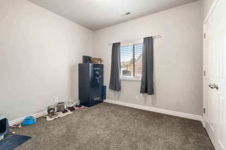 Carpeted flooring, light wall tones, white trim, and a window with blinds