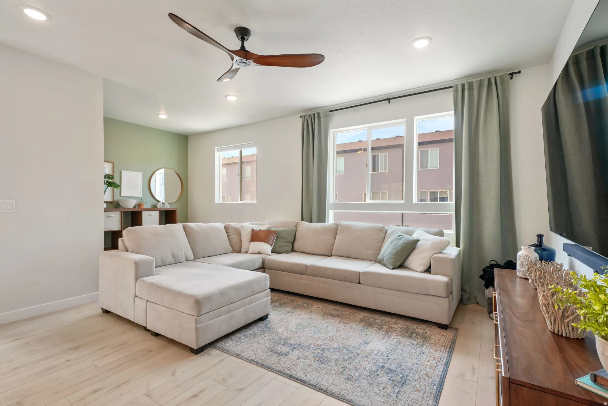 Recessed lighting, wood-finish flooring, and a contemporary ceiling fan
