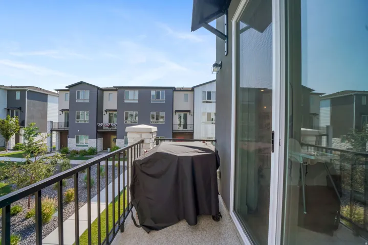 Private balcony with a concrete surface and black metal railing
