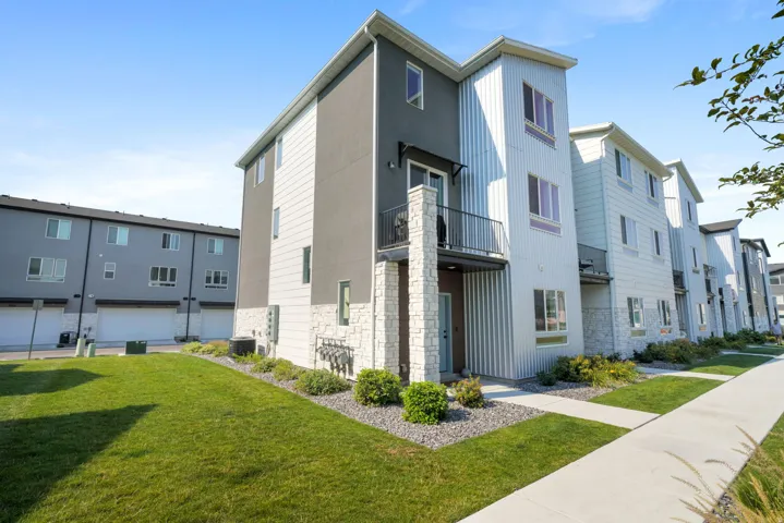 Modern exterior featuring corrugated metal siding, stucco, and stone accents
