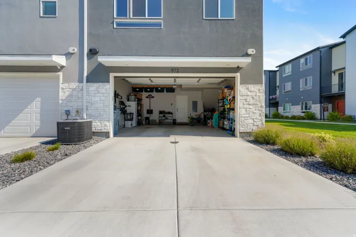 Concrete driveway leading to an attached garage with an overhead door