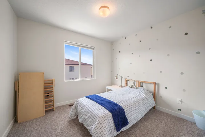 Carpeted flooring, white walls, and a window providing natural illumination
