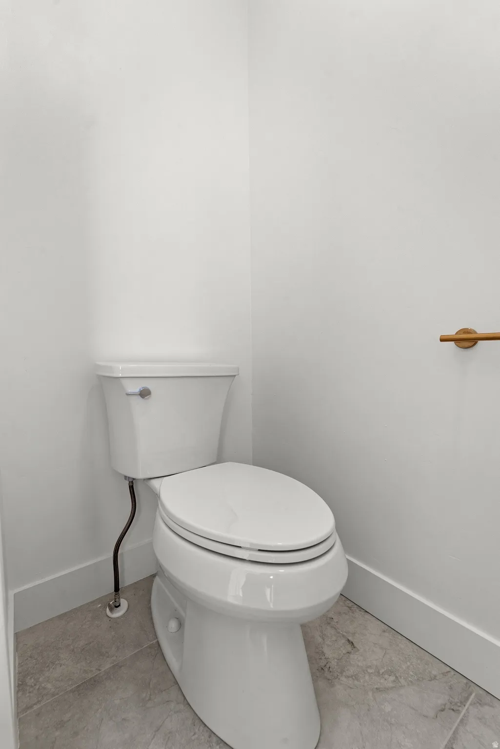 White commode with a round bowl and lid