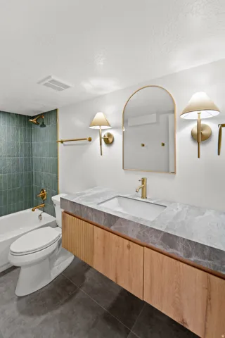 Floating wood-finish vanity with a stone-finish countertop and integrated sink